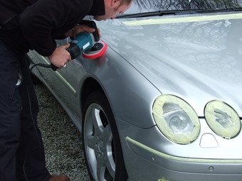 Polishing the car to a high gloss finish.